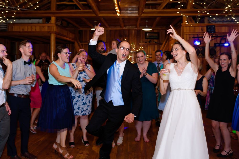 Bride and groom letting loose on dance floor during wedding reception at Crystal Brook Farm in Chagrin Falls, Ohio.