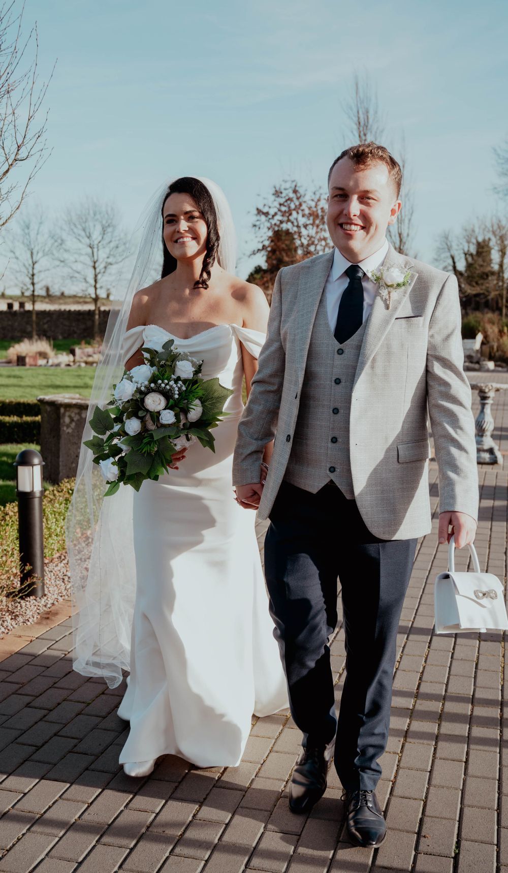 Newly married couple waking through Darver Castle grounds