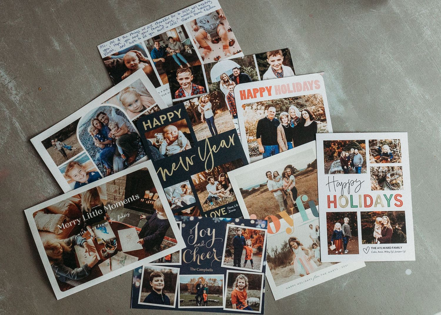 Collection of printed photo memories scattered on a gray surface.