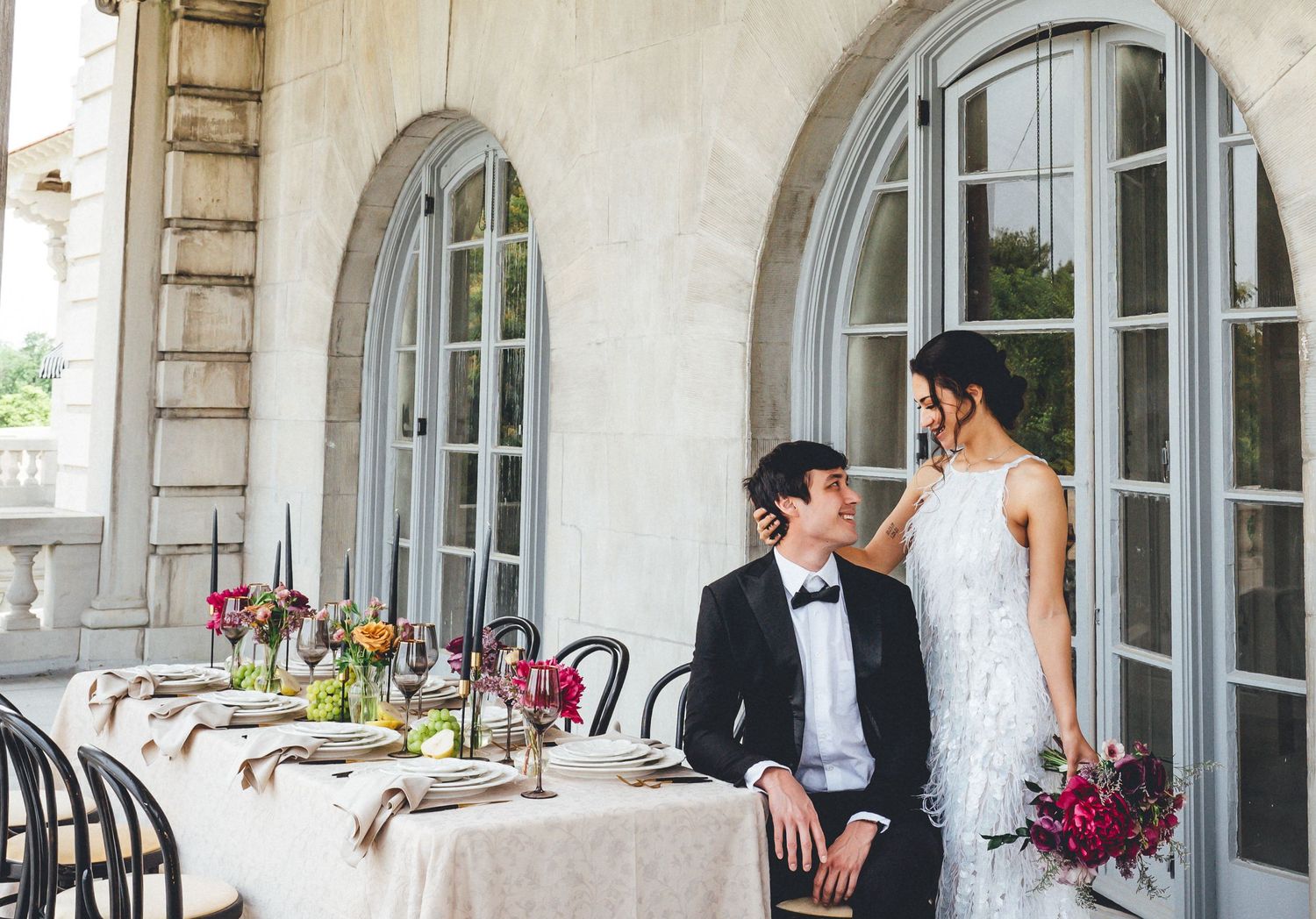 Bride and groom share their reception table on the rooftop of the Elkins Estate.