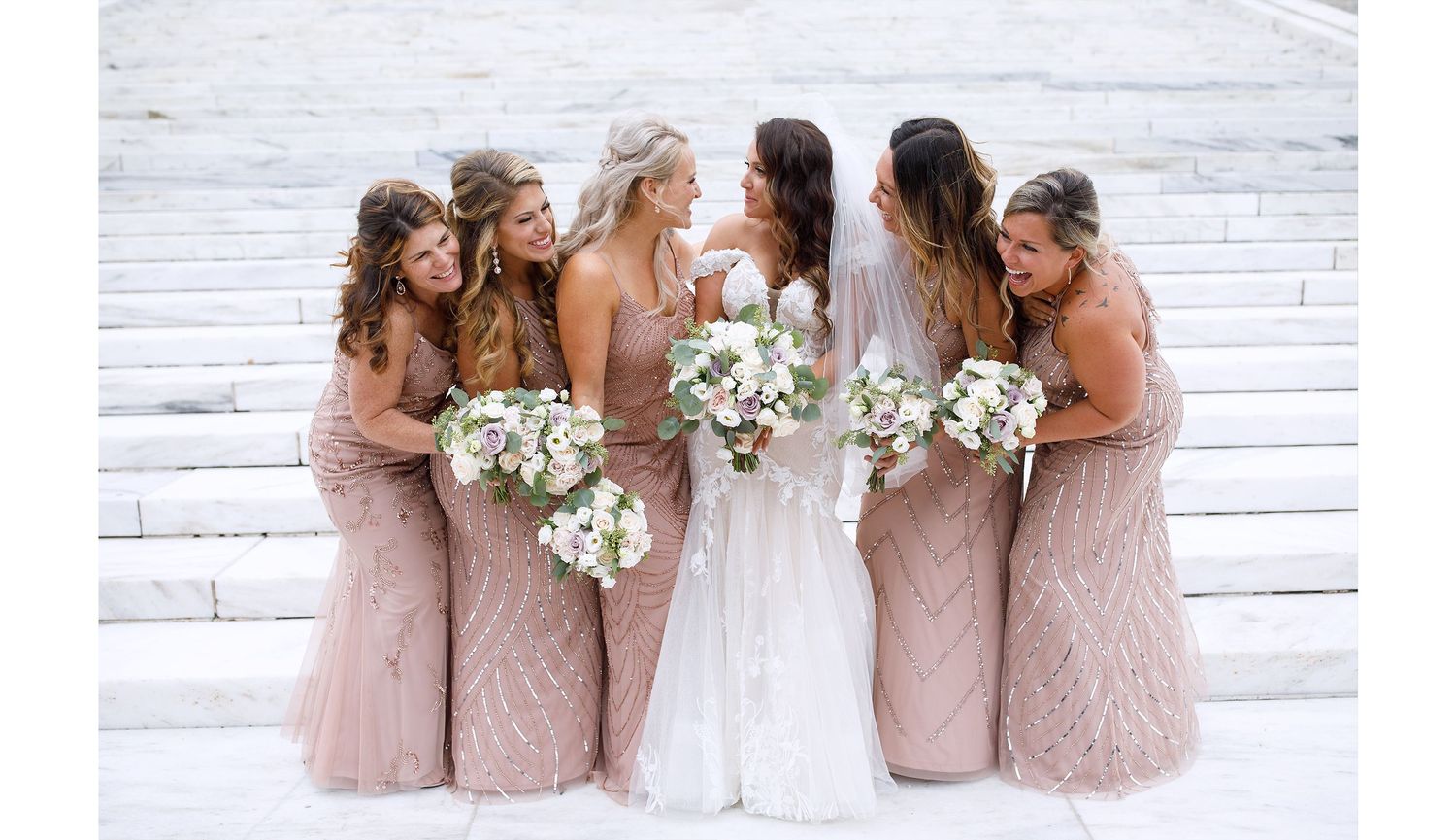 Bridal party portrait on elegant white steps. Serving Providence, Boston, and Newport with expert wedding and family photography