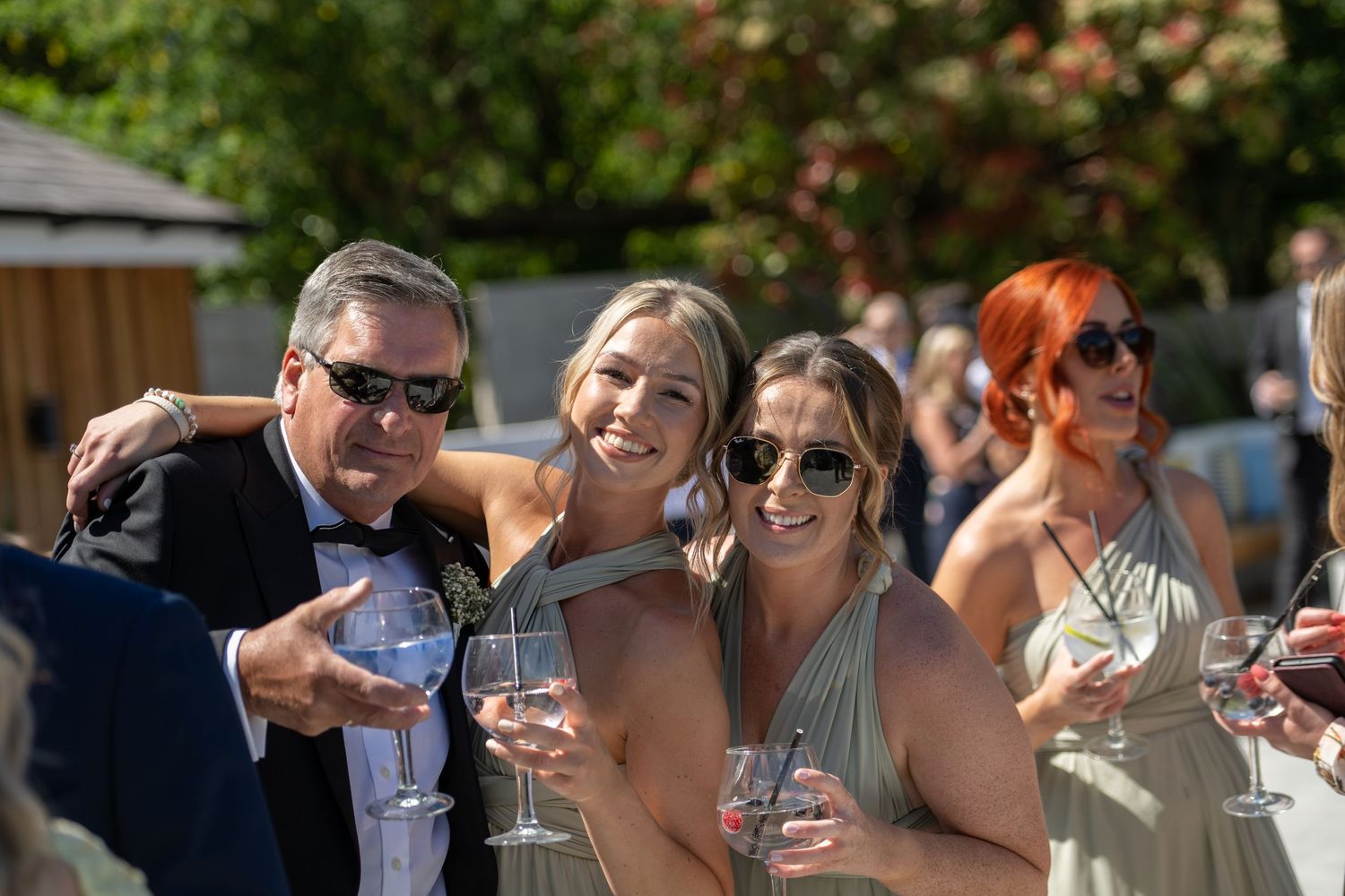 Wedding guests enjoying drinks and conversation during an outdoor reception.
