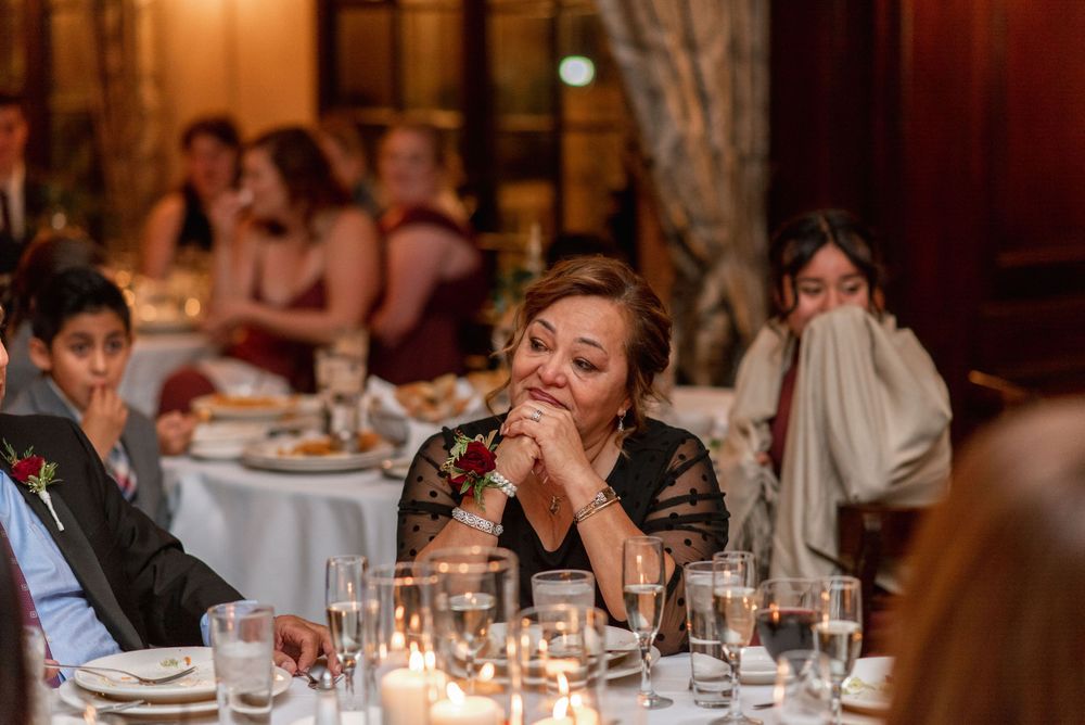 Candlelit reception dinner scene with guests seated at elegantly decorated tables.