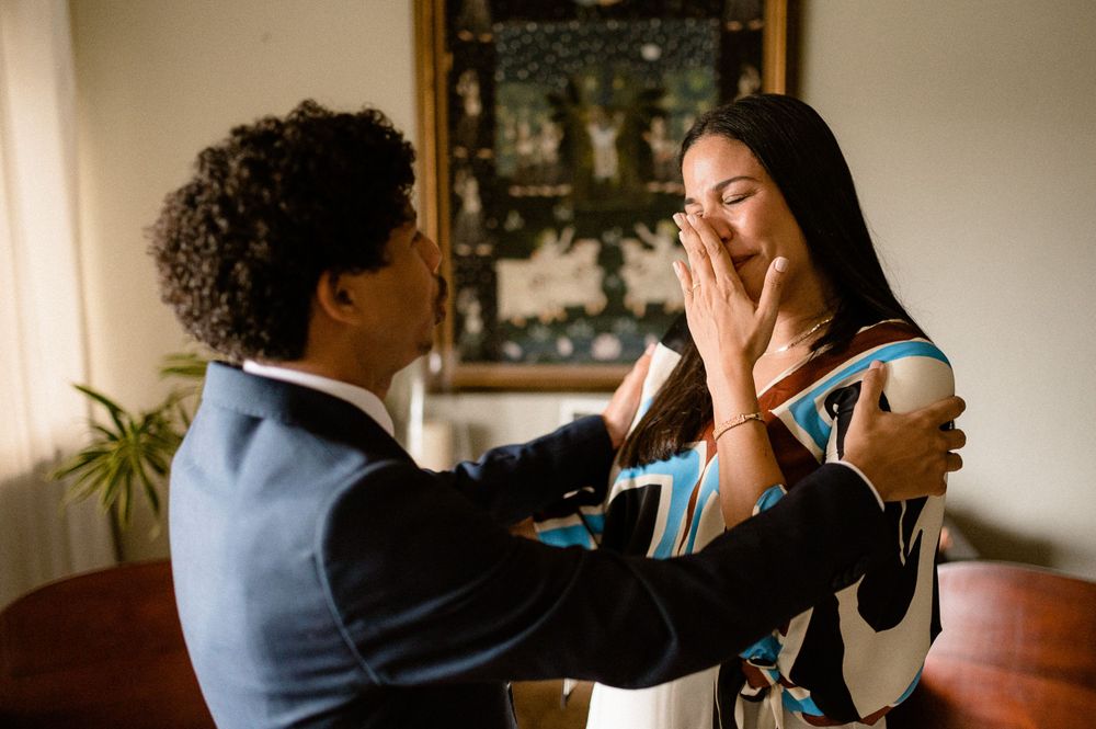 Emotional couple sharing a joyful moment in their living room.