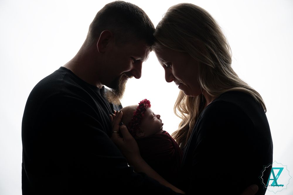 Silhouette portrait captures intimate family moment against white background.
