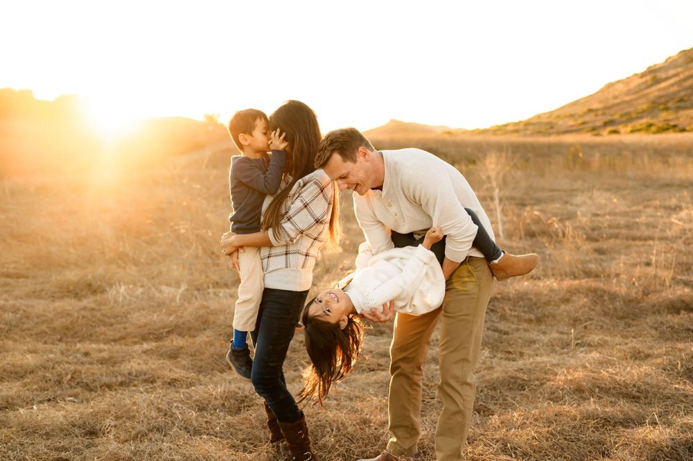Santa Barbara golden field family photos by Ventura family photographer of family playing with their two young children during photoshoot