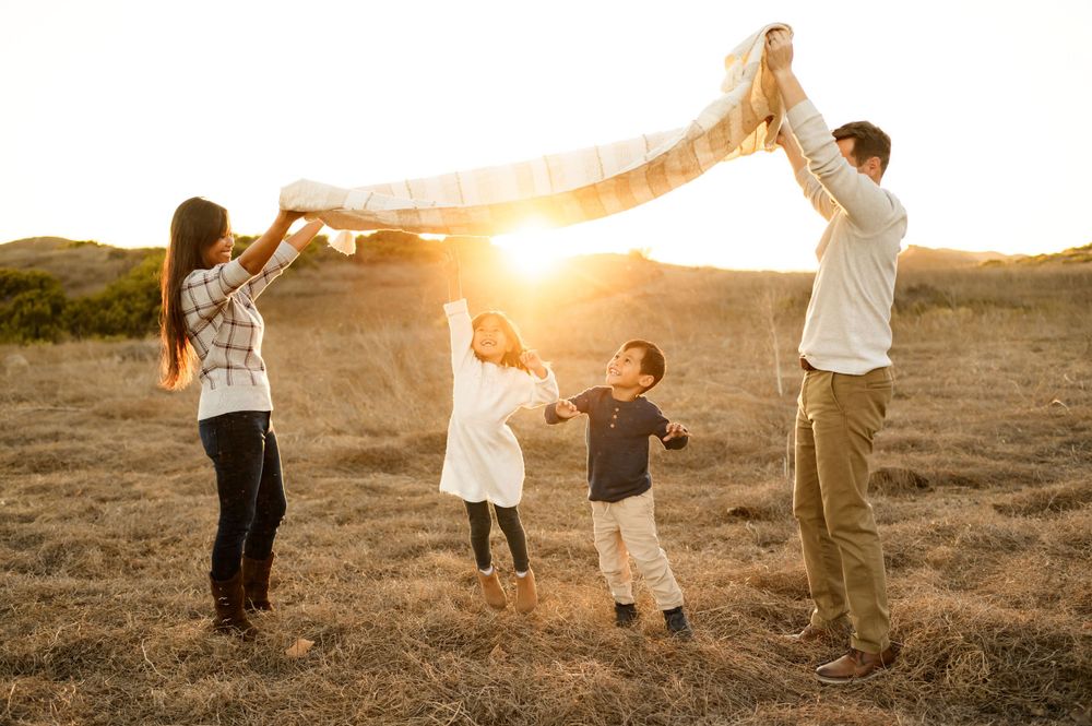 Santa Barbara golden field family photos by Ventura family photographer of family playing with their two young children during photoshoot