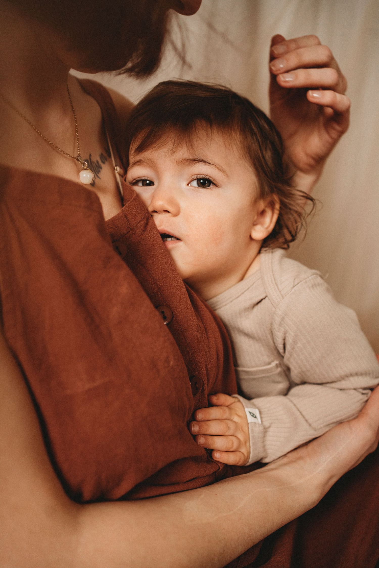 Tender moment between parent and child in warm natural window light.