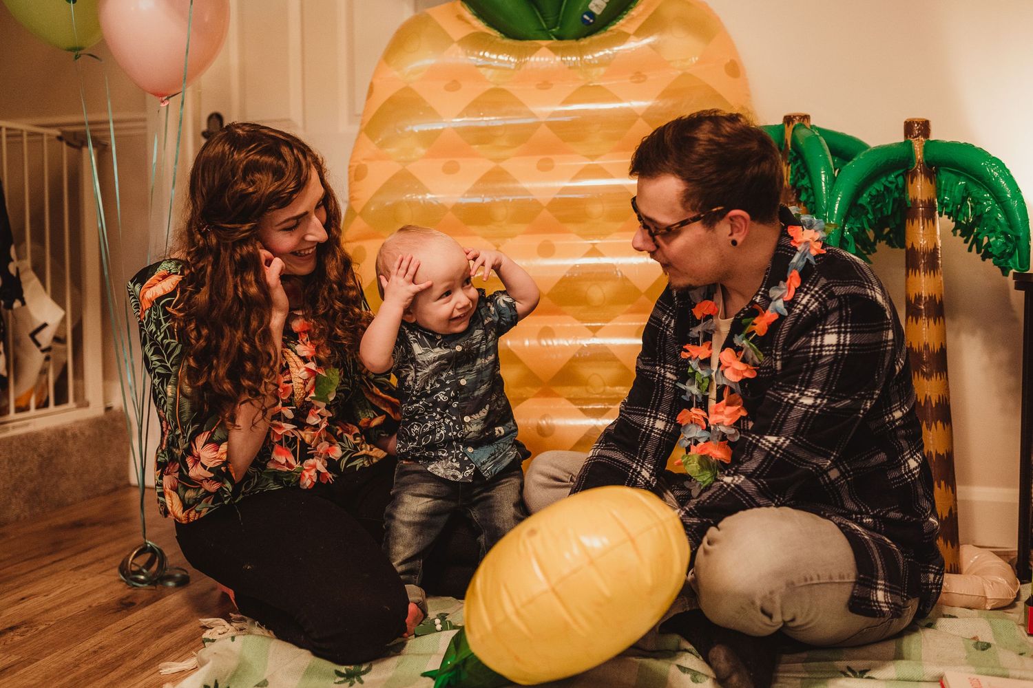 birthday boy standing between his mummy and daddy who are both interacting with him