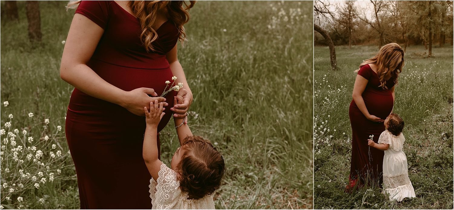 Sweet interaction between mother and child in a field with white wildflowers at sunset.