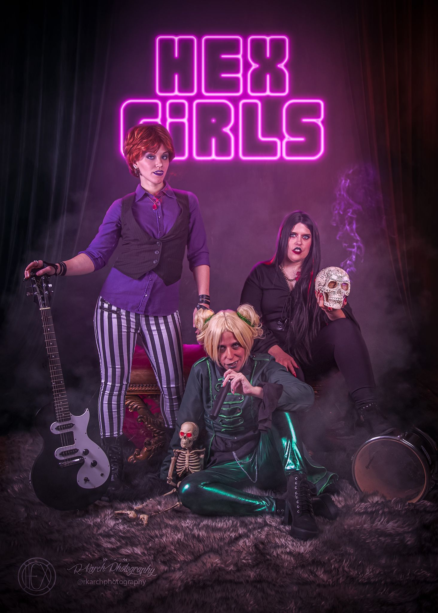 Alternative rock band poses dramatically with instruments and neon sign in dark moody setting.