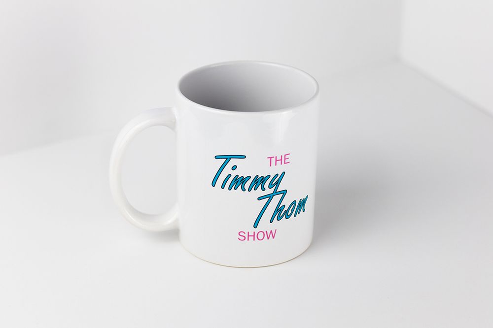 Clean white coffee mugs with blue and pink text arranged in a minimalist composition.