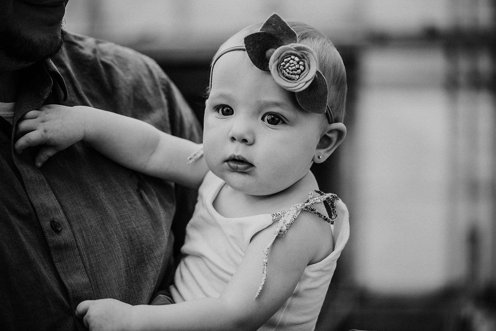 Black and white portrait of small child wearing decorative headband.