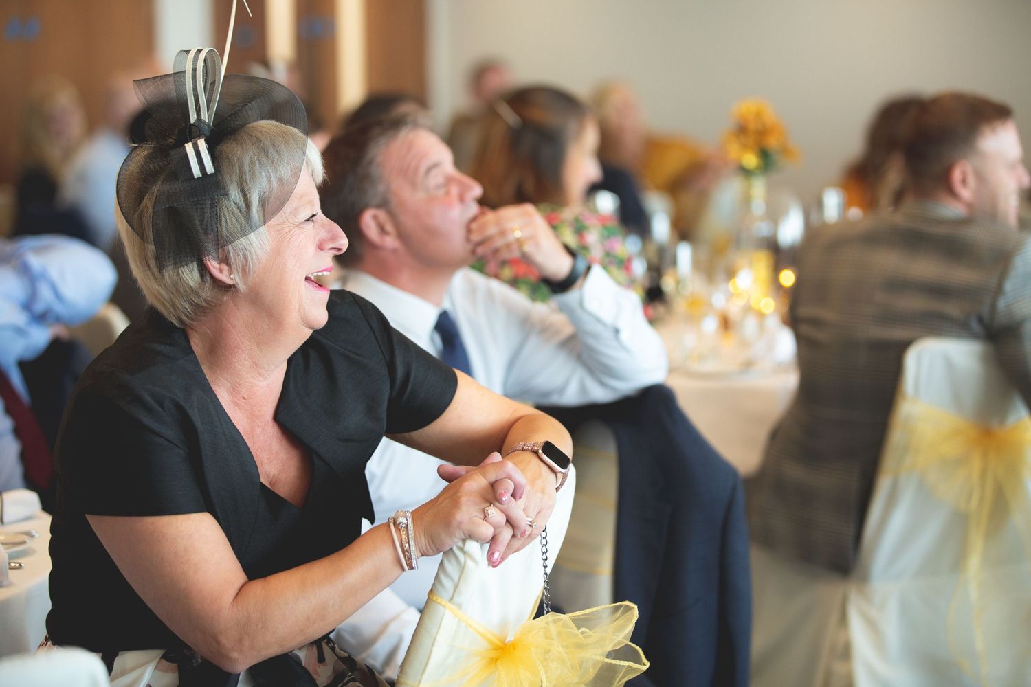 Guests sharing laughter and creating joyful moments during an elegant indoor celebration.