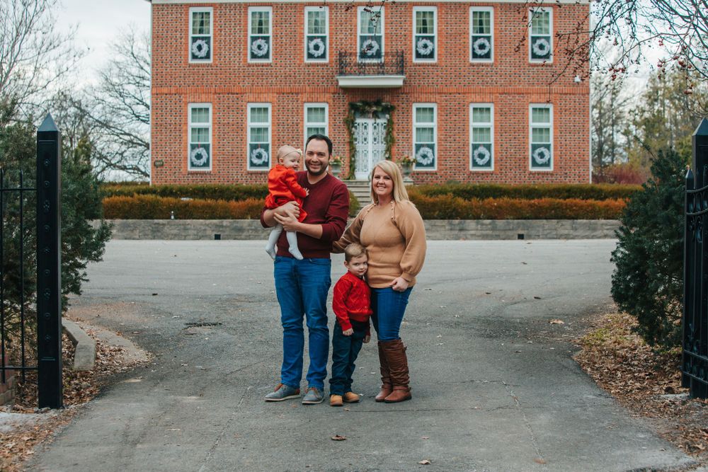 Family photo sequence in front of a brick building with numbered windows.