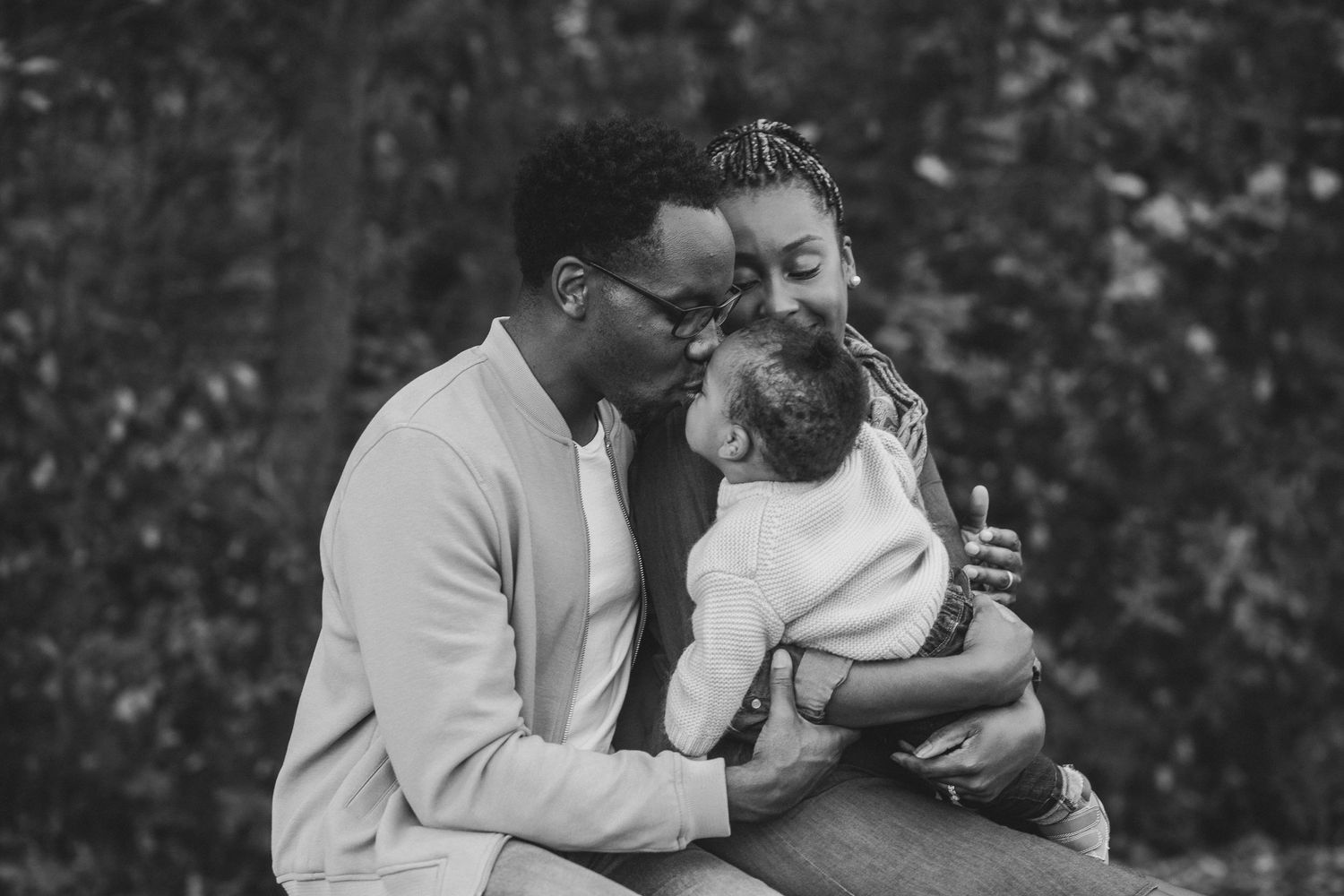 Black and white portrait of tender family moment together.