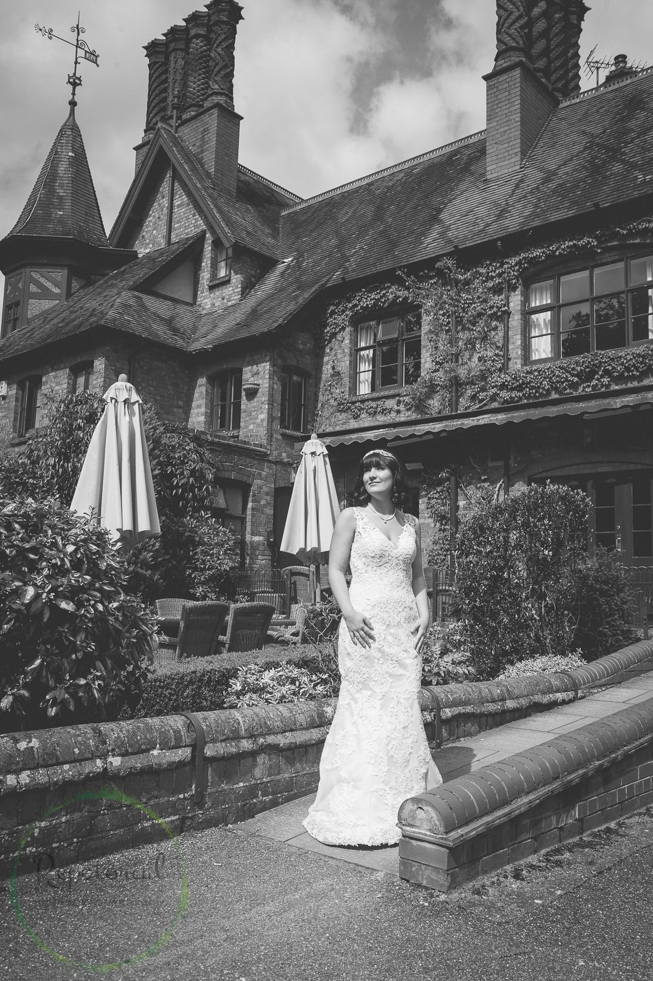 monochrome black and white photo of bridge in front of hotel before her wedding
