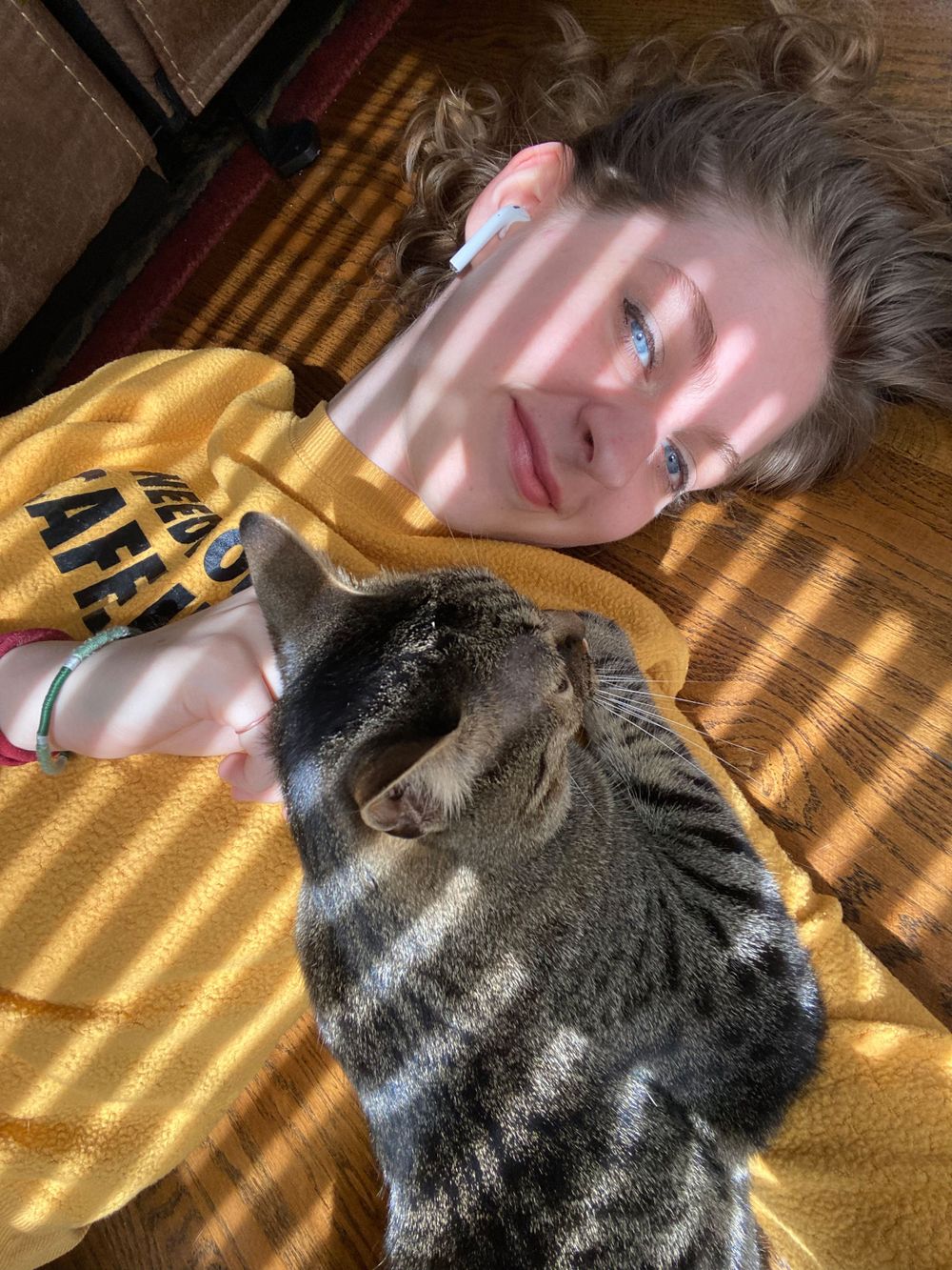 Woman laying on the ground in the sun with a cat in Greenville, South Carolina