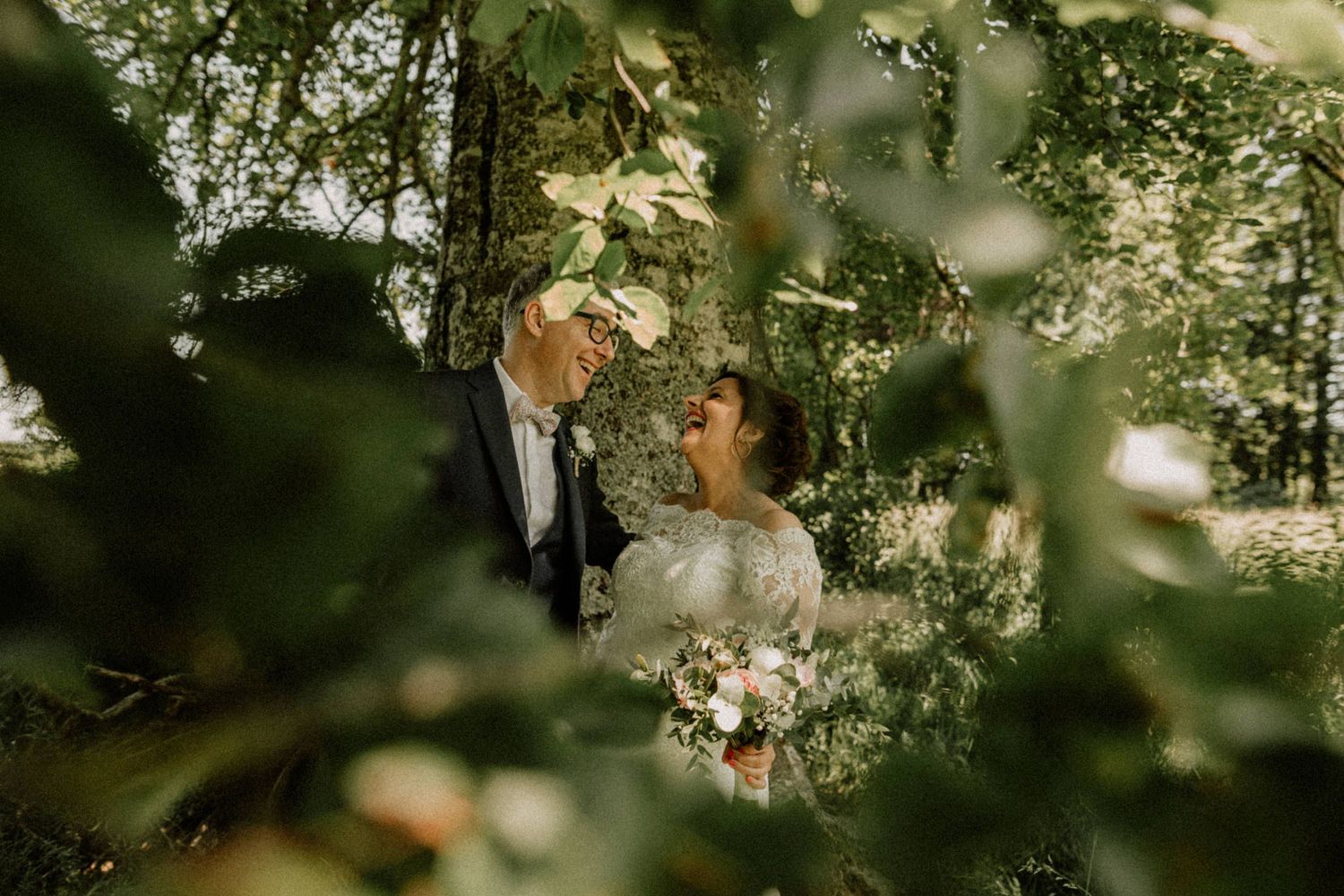 bride and groom laughing hard after their wedding ceremony at chateau d'azy france