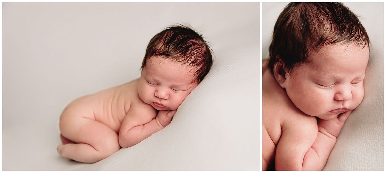 baby boy posed for newborn photos on white blanket