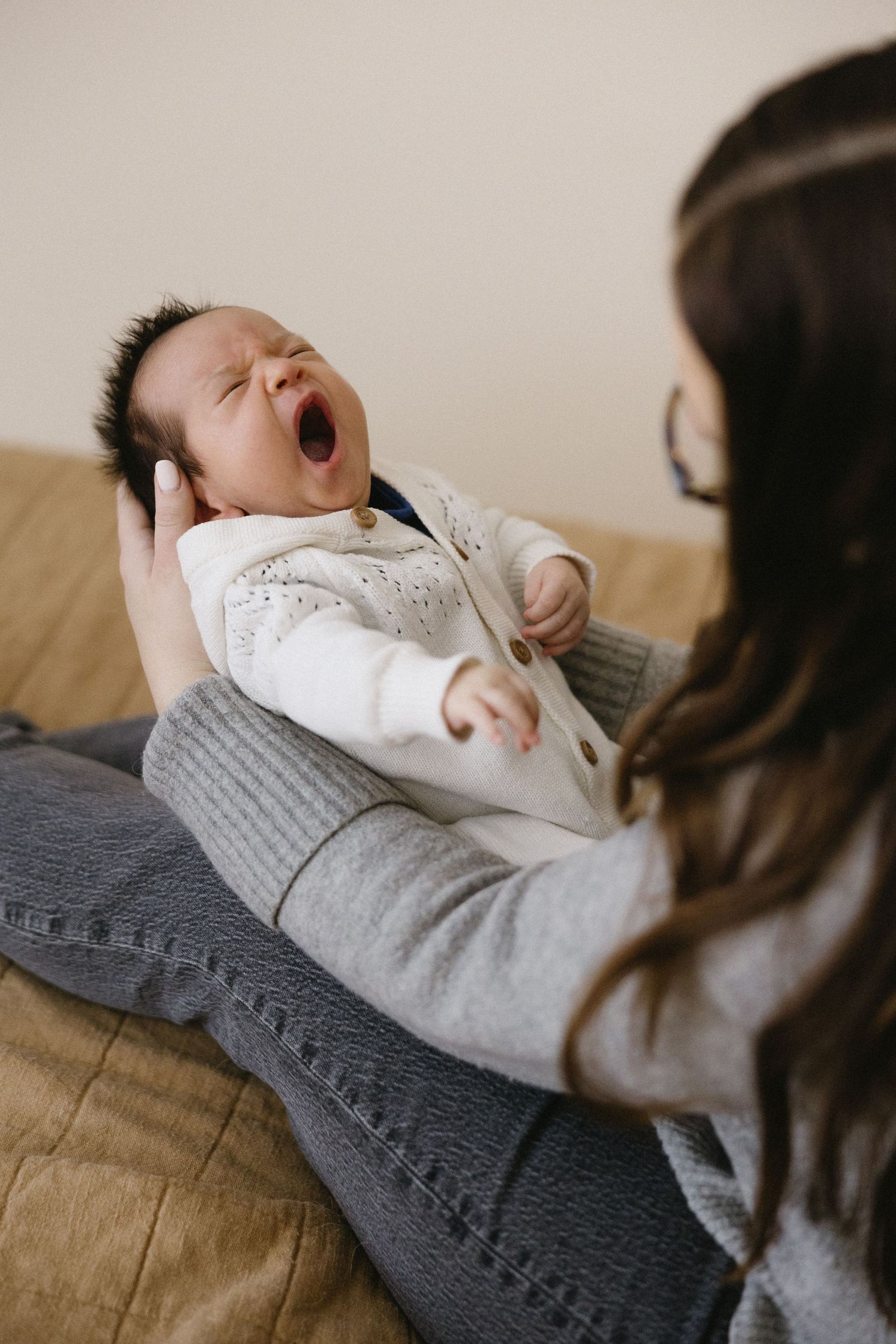 Family photo session with newborn baby yawning