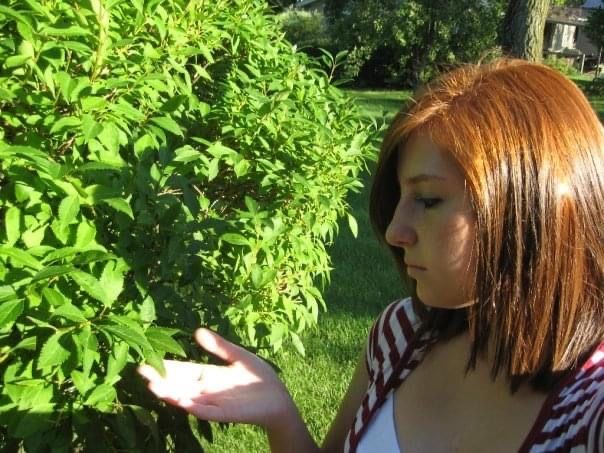 Profile views in outdoor garden setting with lush green foliage.
