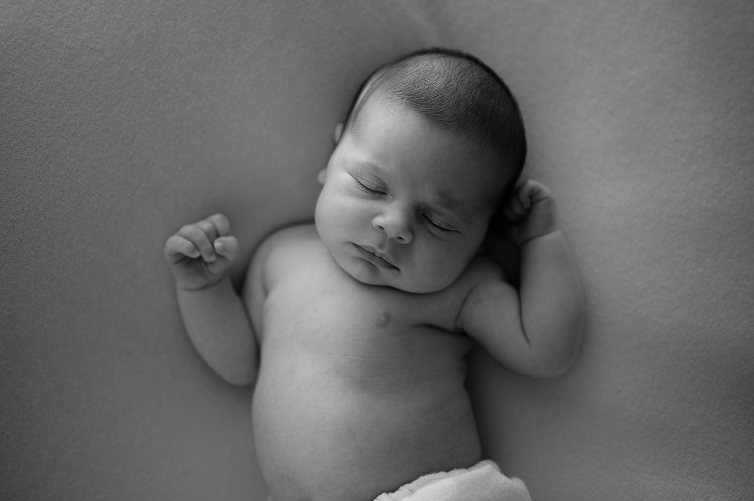 Peaceful black and white portrait of a sleeping newborn baby.