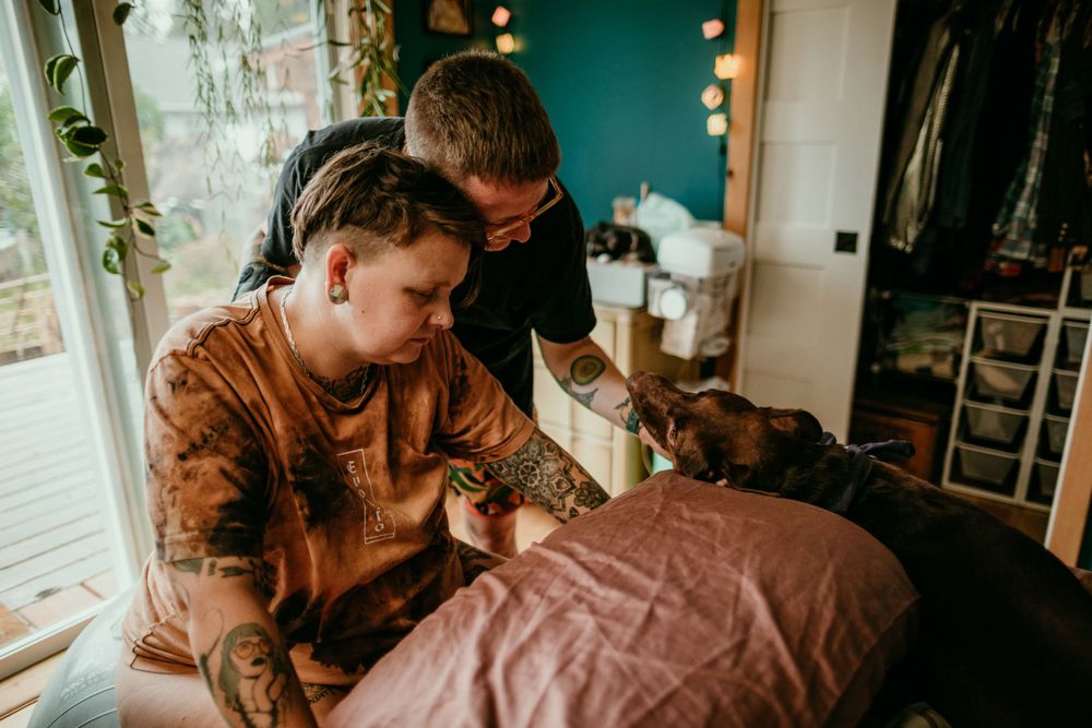 queer trans family with dog during labor home birth photographer portland oregon