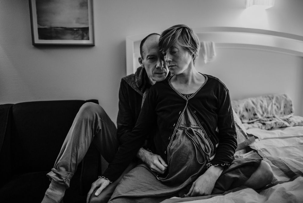 black and white image of partner supporting birthing person birth photographer portland oregon