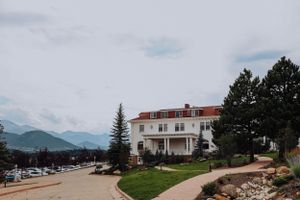 Panoramic view of a white building complex against mountain landscape.