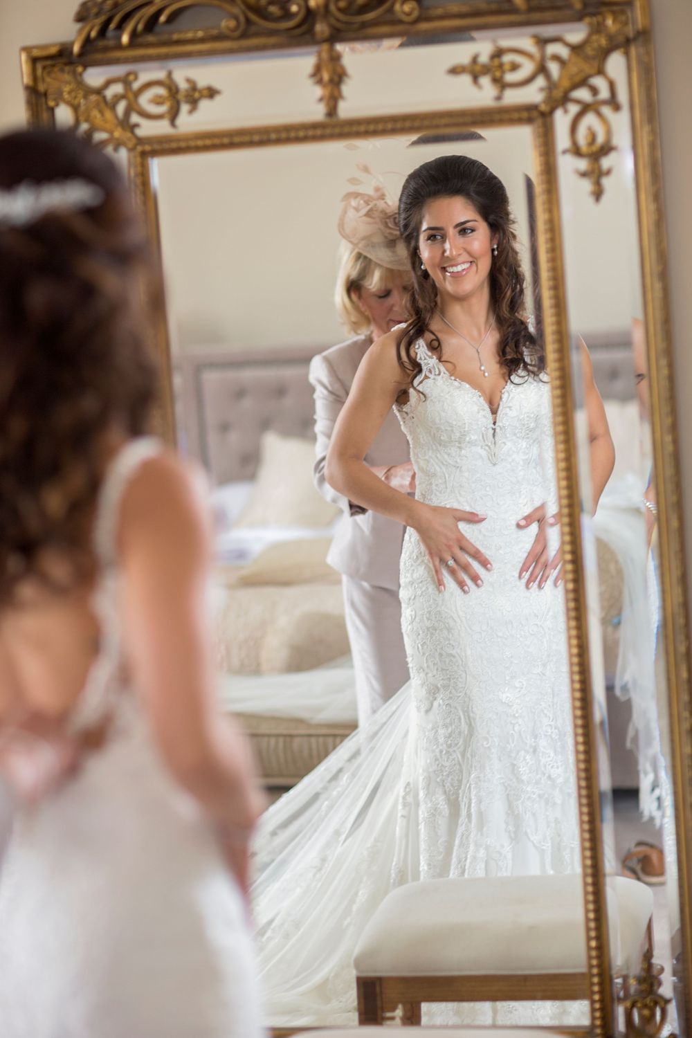gorgeous bride and her mum getting ready in mirror at St Tewdrics House Chepstow