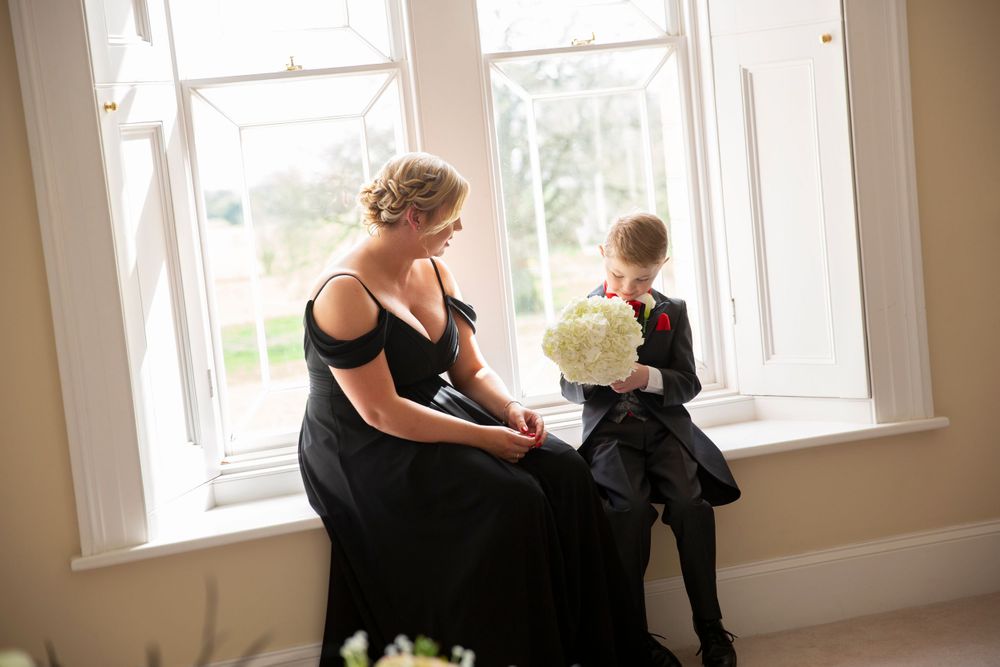 charming candid moment bridesmaid with her son at window in St Tewdrics Wedding