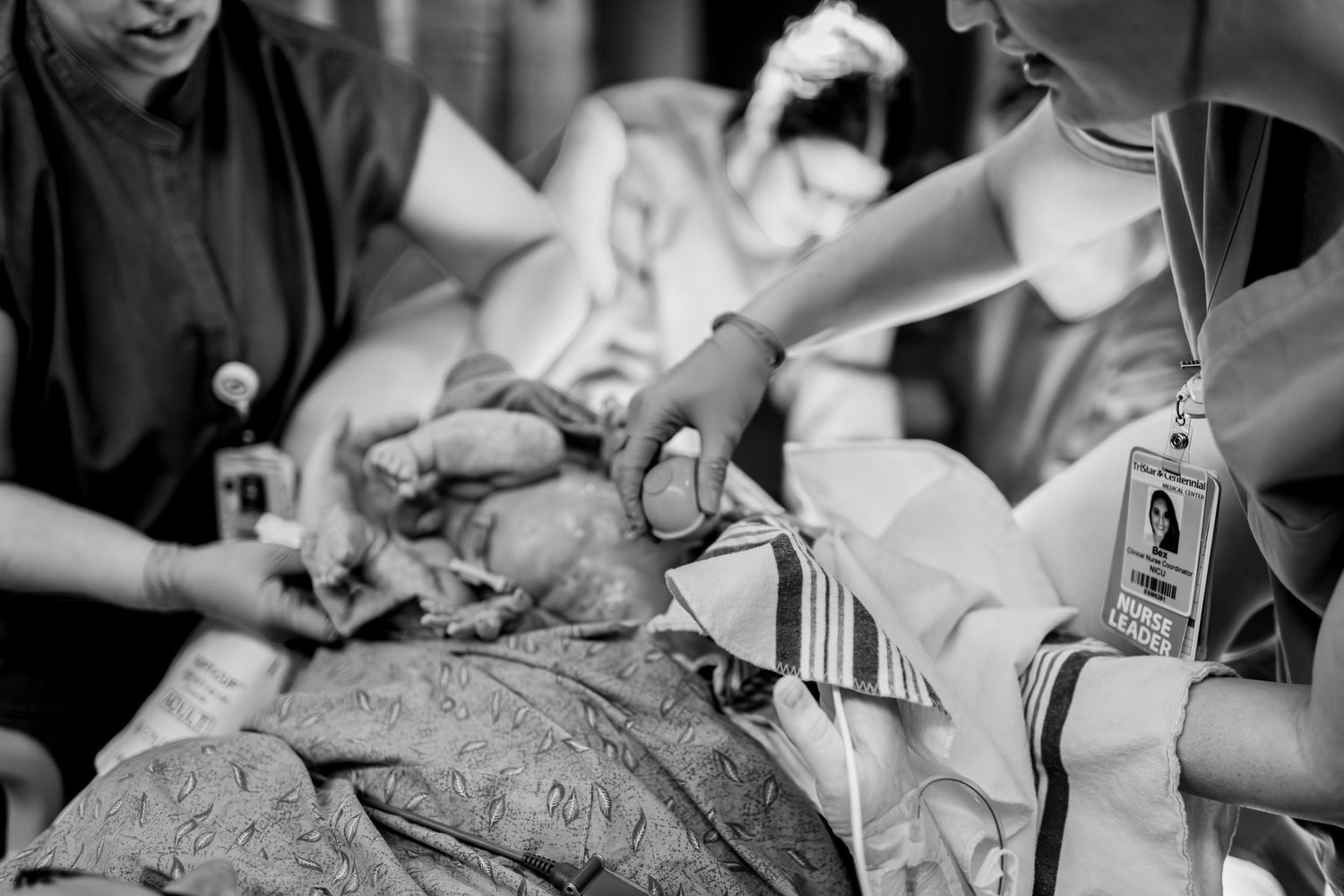 Medical team performing a procedure in black and white.