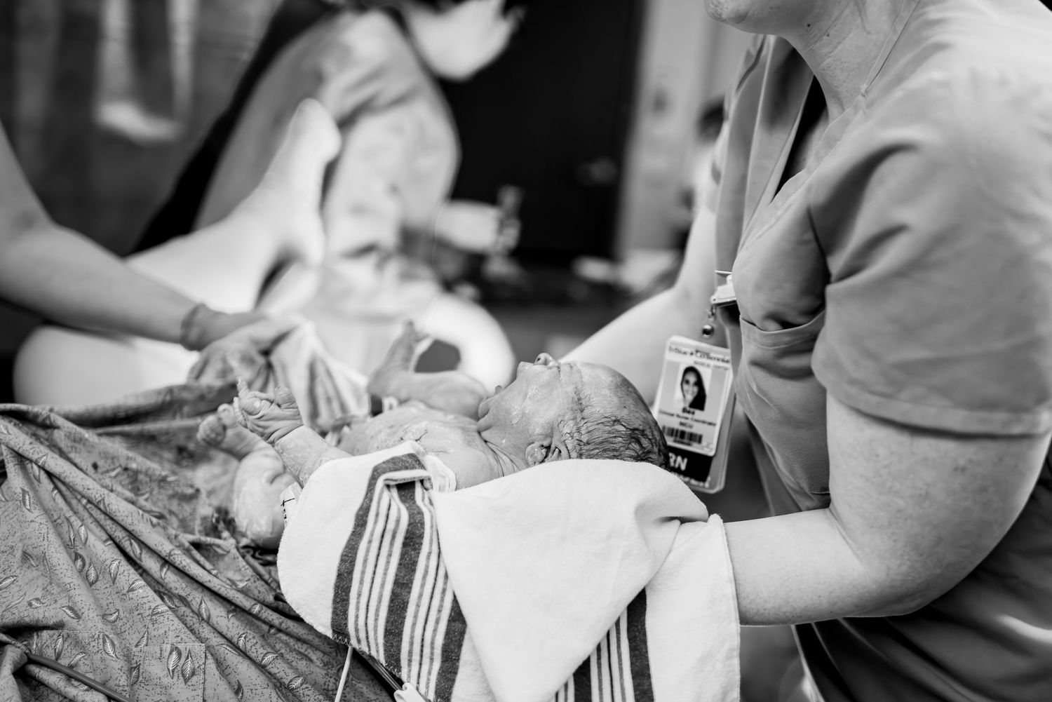 Healthcare workers providing medical care in a clinical setting.