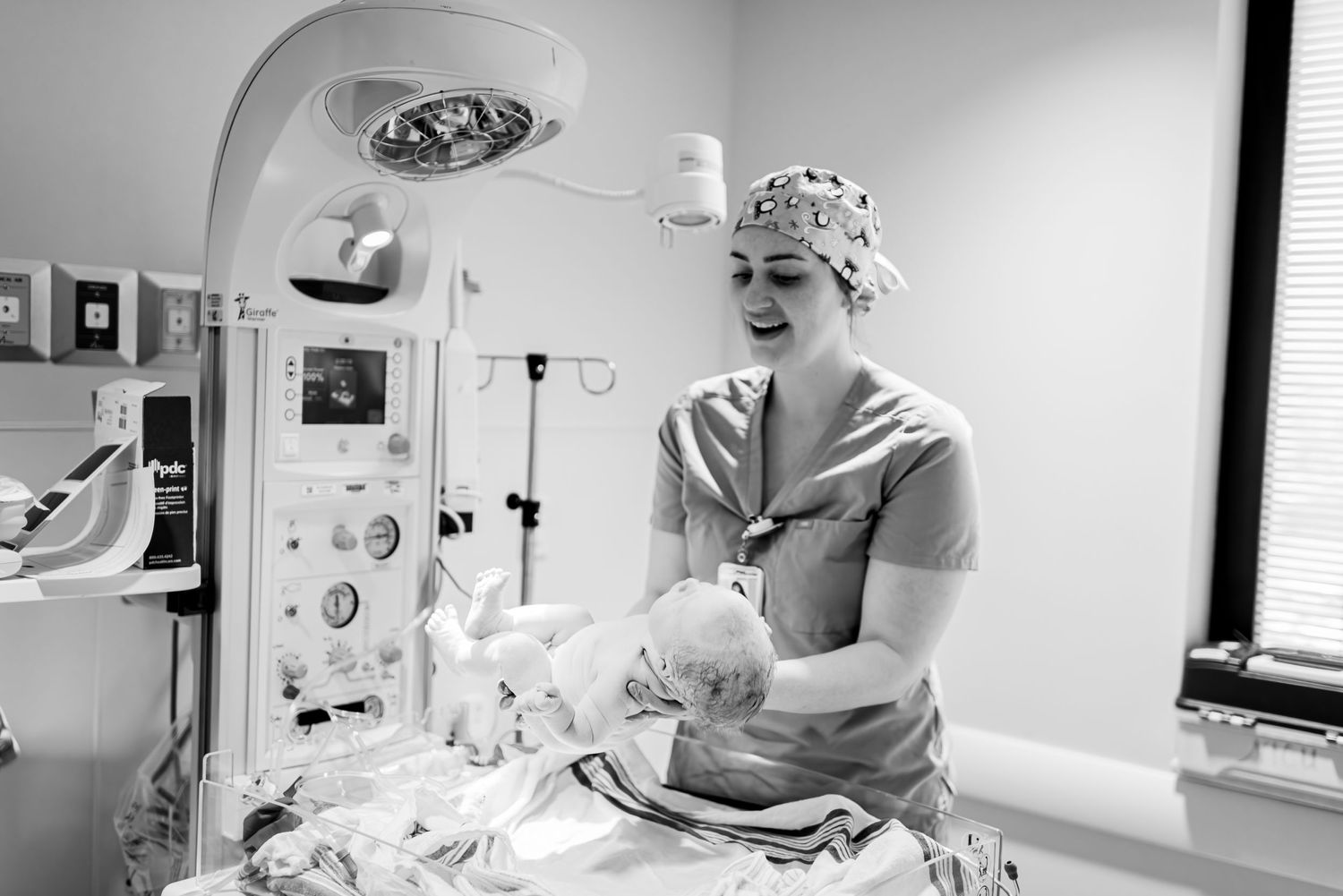 Medical professional attending to a patient under examination lights.
