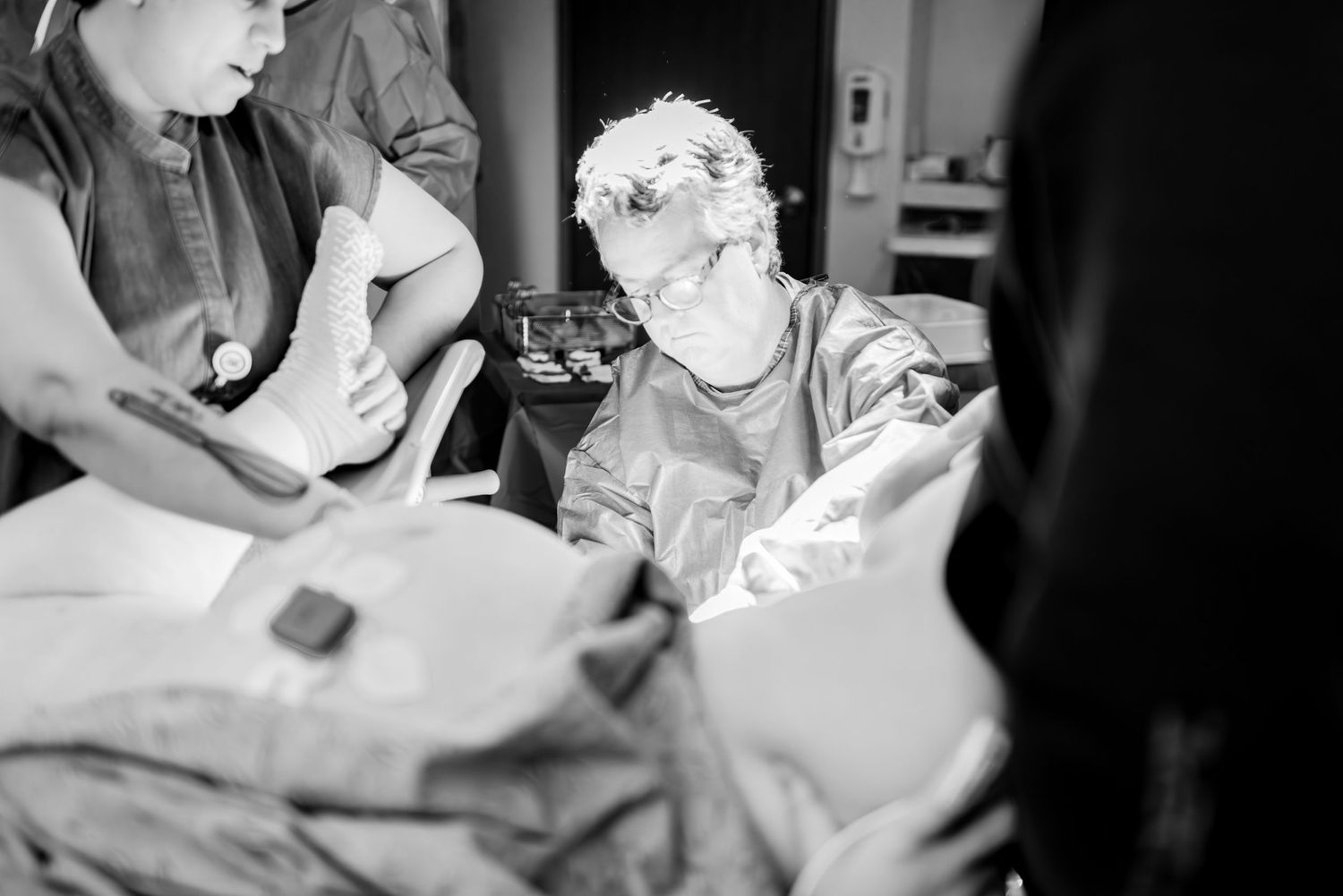 Medical professionals working together in an operating room environment.
