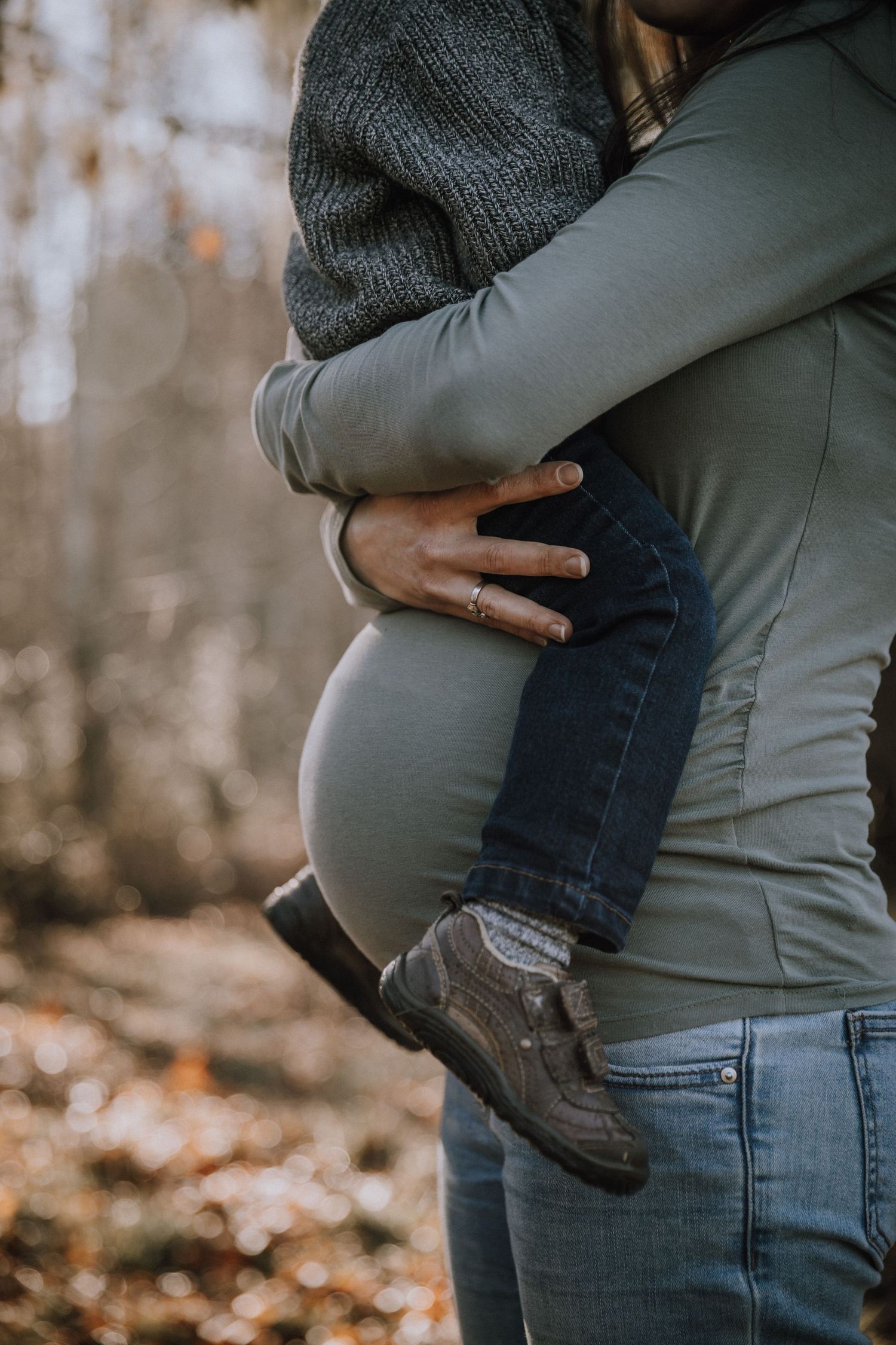 Pregnant mom holding young son