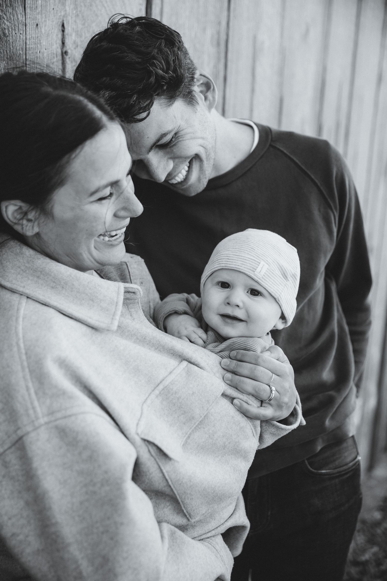 Baby in mom's jacket while everyone smiles