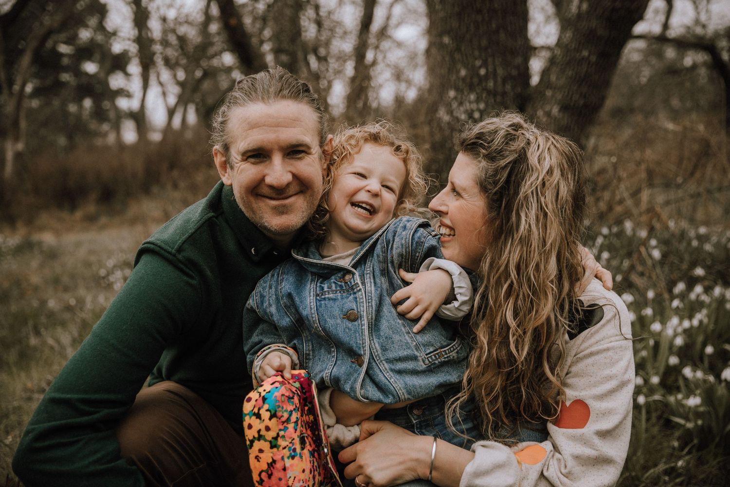 Spring time cuddles of family of three