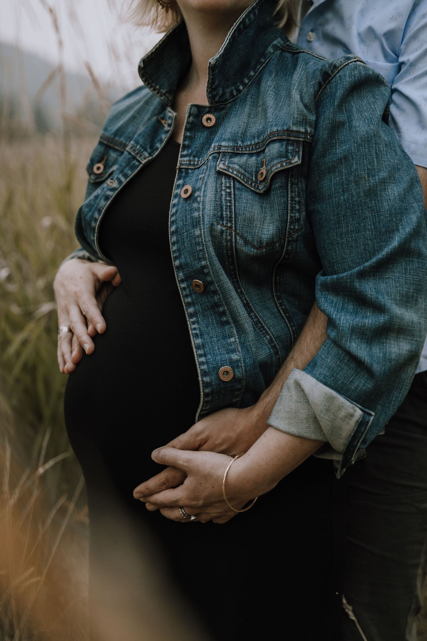 Maternity shot of belly that mom and dad hold adoringly