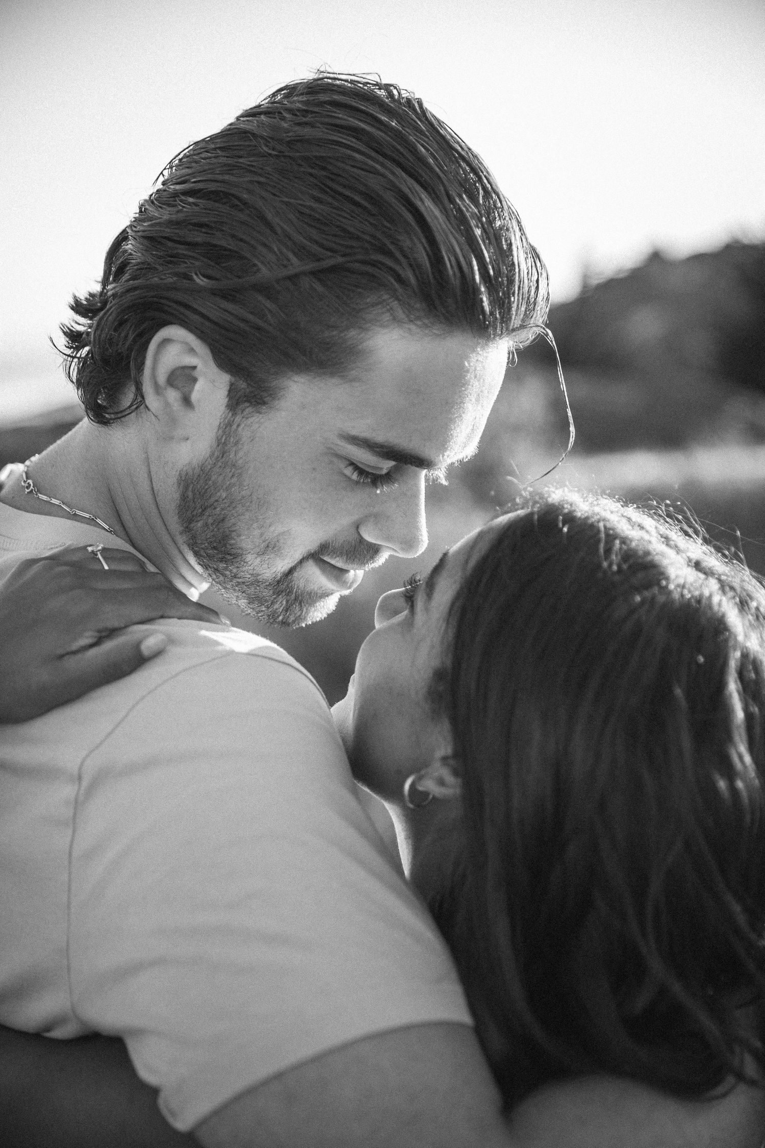 Boyfriend gazes into girlfriends eyes at sunset