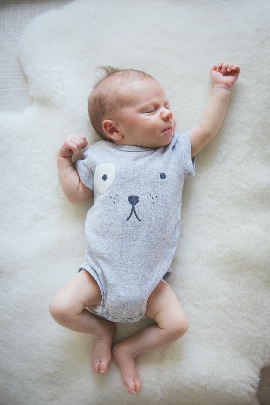 Newborn baby sleeping on sheep skin