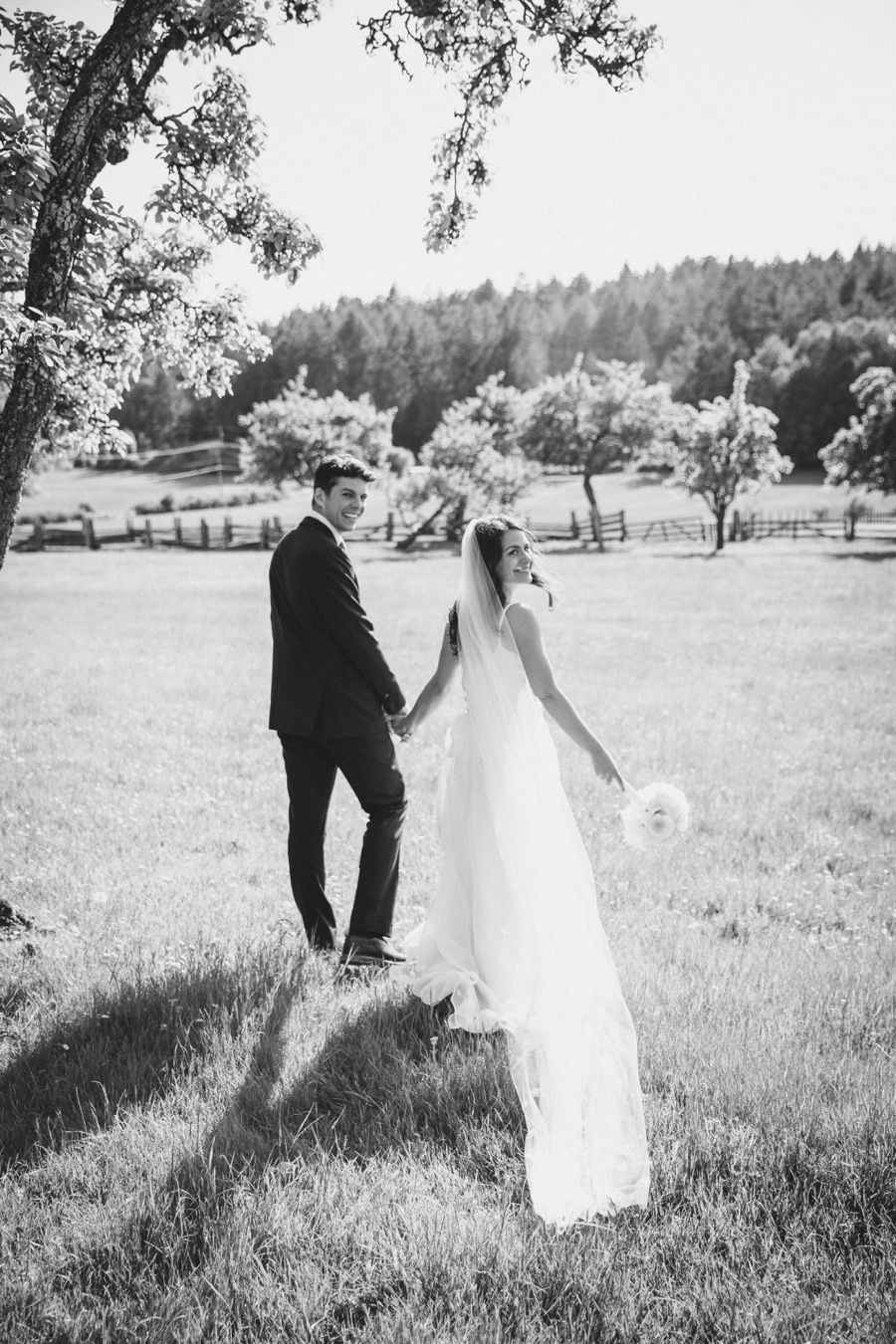 Bridal couple looking back as they walk away