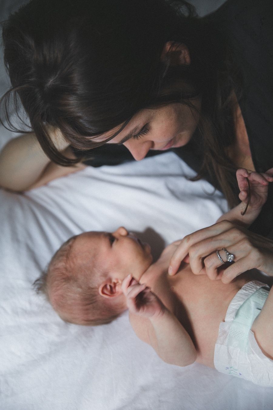 New mom looking down lovingly at newborn baby