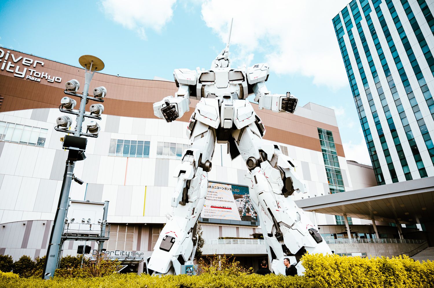 Life-sized Gundam robot statue stands in front of a shopping center in Tokyo.