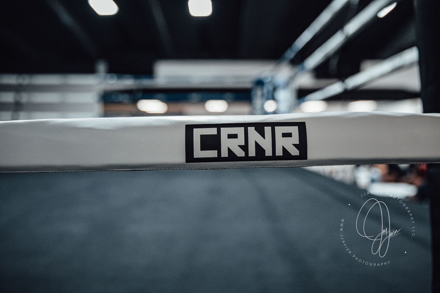 An empty industrial space with fluorescent lighting and a CRNR sign visible.