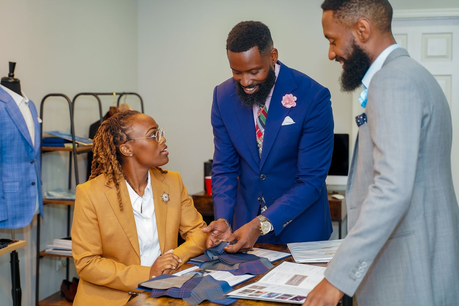 Business professionals in formal attire reviewing documents together in an office setting.