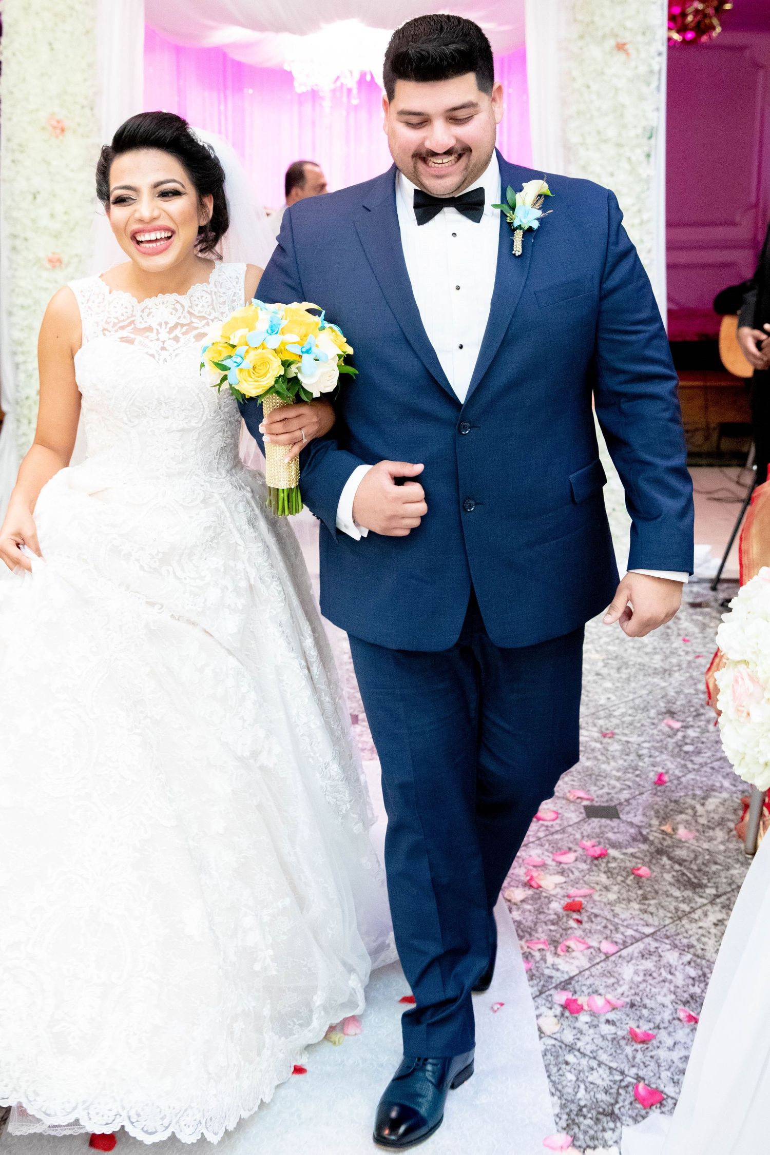 Bride and groom holding bouquet after wedding.
