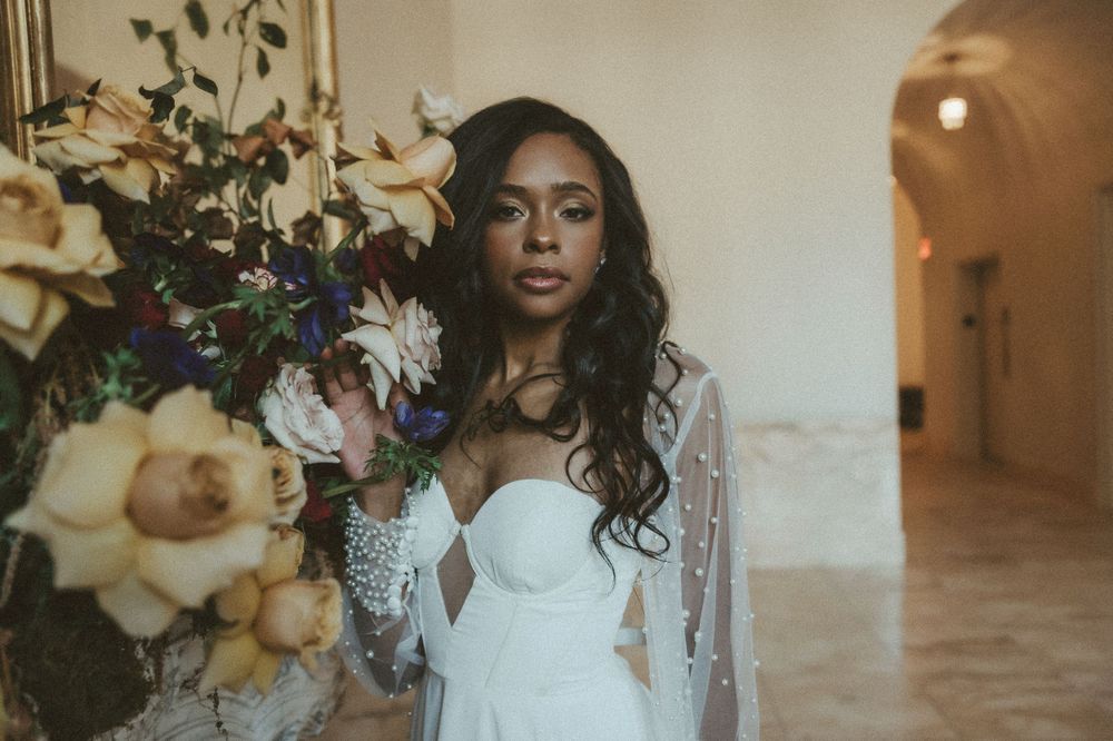 Romantic bridal portrait with cream and peach floral arrangement.