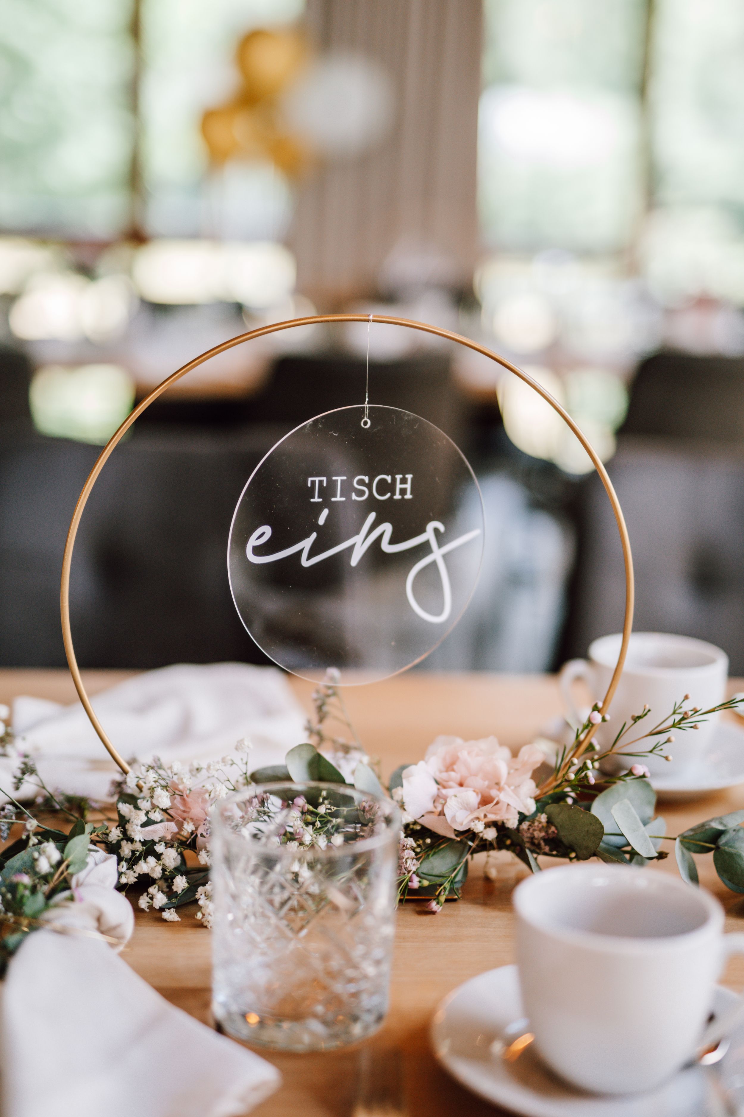 Elegant wedding table setting with delicate floral centerpieces and name cards.